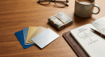 Credit cards fanned out with cash and notebook